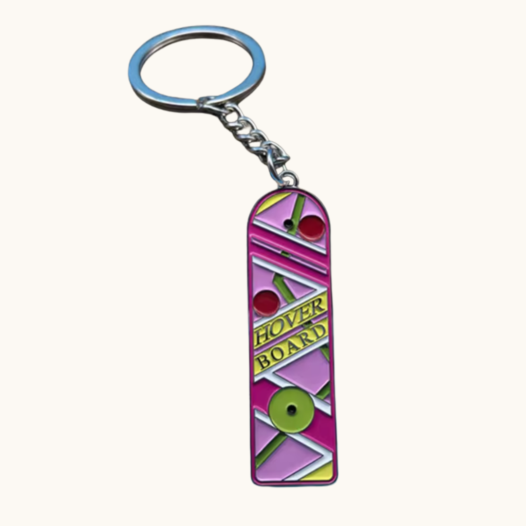 Pixel Bit hoverboard keychain, small metallic key chain featuring a miniature hoverboard design for accessories or keys.